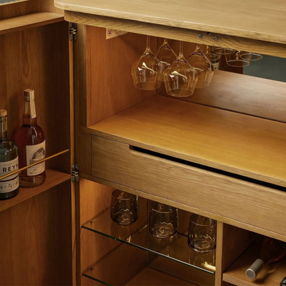 Modern wooden bar cabinet with double doors, bottle storage, wine glass holder, shelves, and home bar storage design.